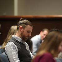 Judges writing on their score sheet